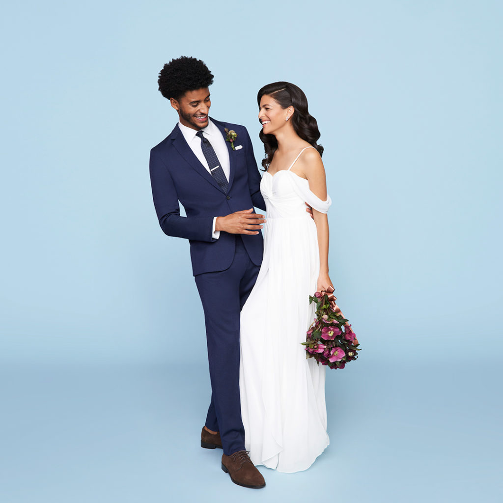 Man in blue men's wedding suit with bride in gown