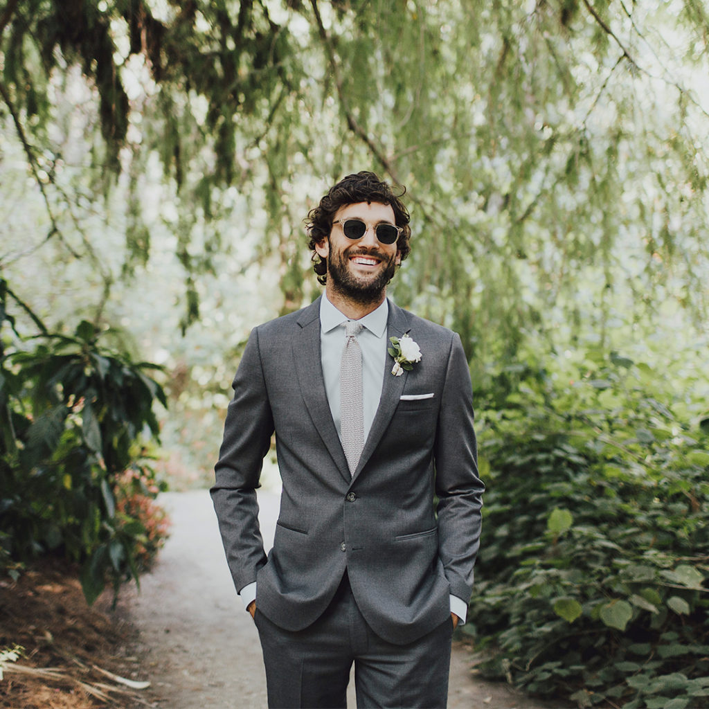 Man in grey men's suit with necktie.