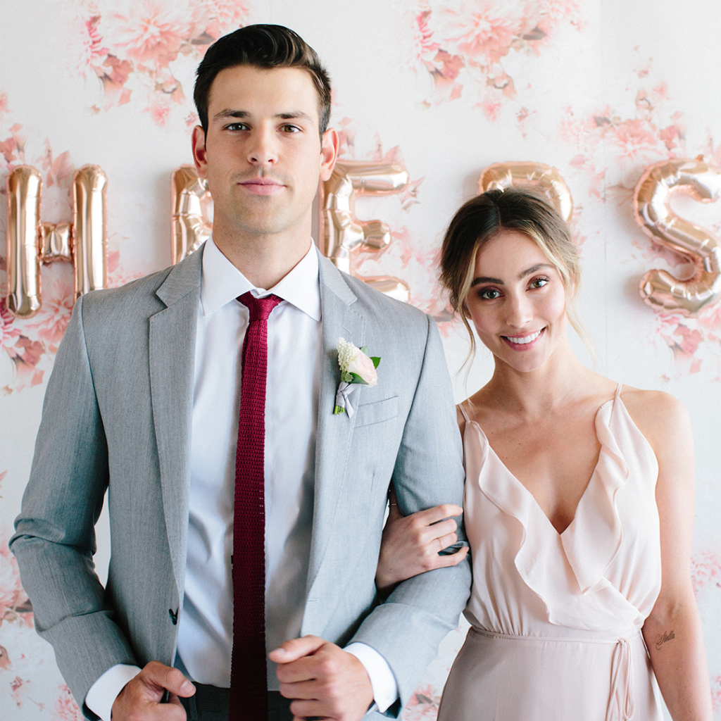 Men in light grey suit for weddings with bridesmaid in blush dress.