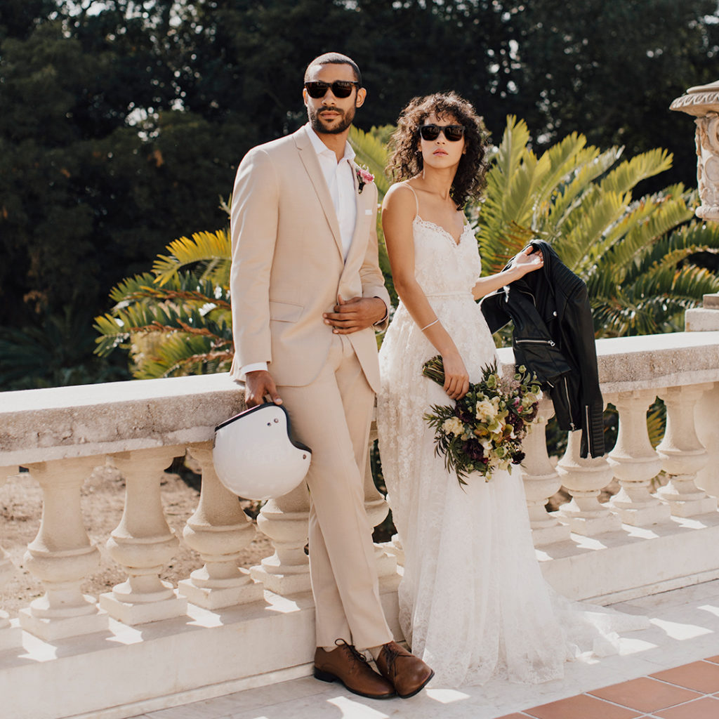 Man in tan wedding suit with woman in white dress.