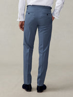 Cropped back view of lake blue tuxedo trousers with navy velvet loafers