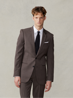 Man wearing a brown suit with a white shirt and black tie.