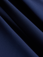 Close-up of cove blue suit fabric, a bright royal blue, draped in soft folds.