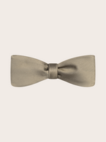 A light taupe bow tie on a plain background.
