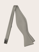 A grey bow tie with a smooth texture and a strap.