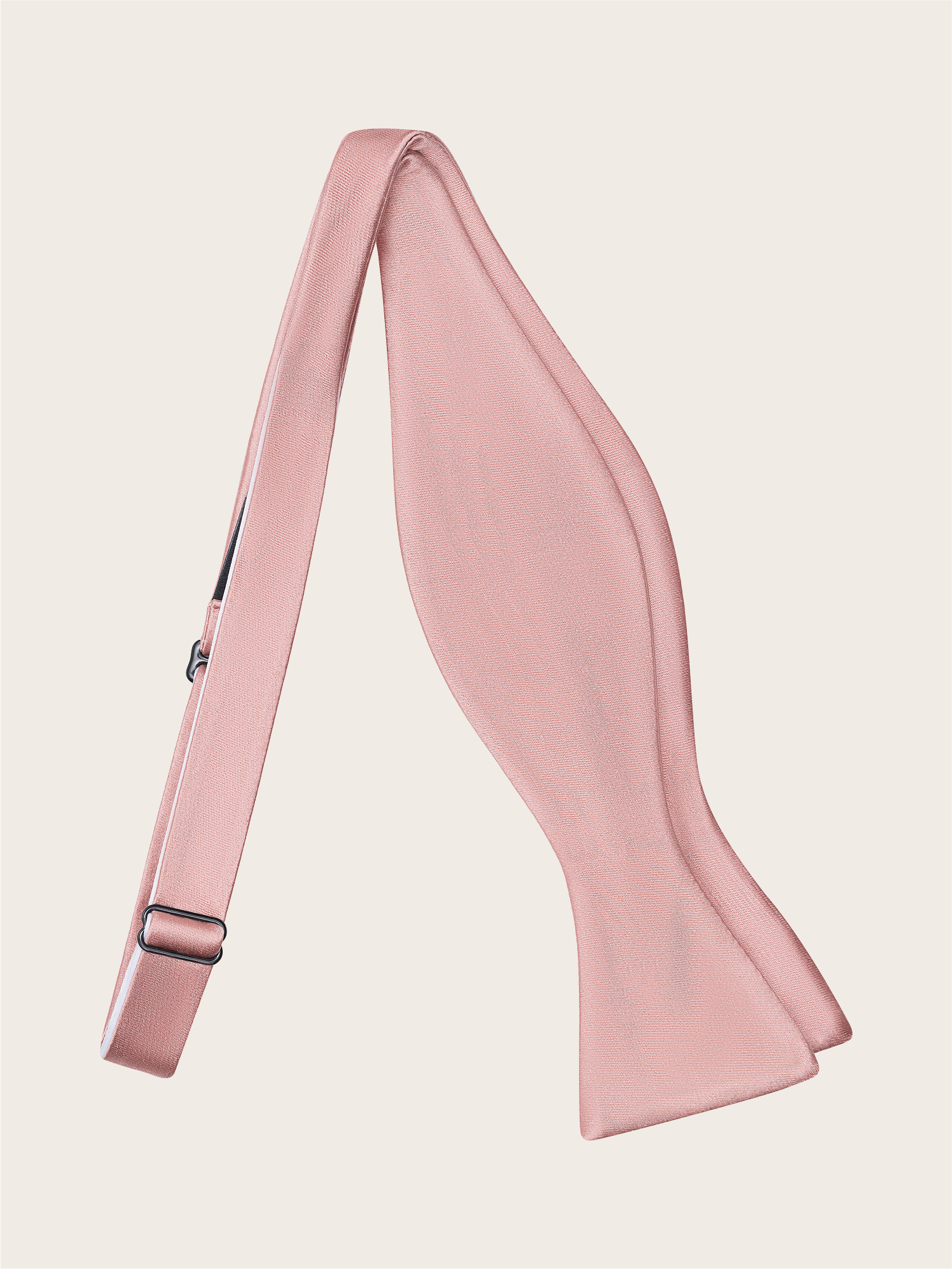 Dusty rose bow tie against a light background