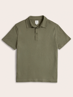 Olive green pique polo shirt laid flat, front view, on cream background