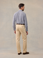 Back view of man in checked shirt and khaki chino trousers, full-length