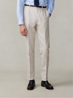 Man wearing light beige trousers, blue shirt, and dark shoes.