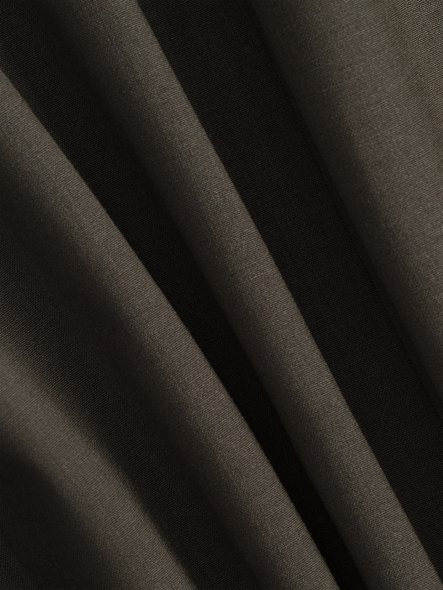 Close-up of dark fabric with visible texture and folds.