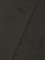 A close-up of a olive green fabric, featuring a suit lapel with a pocket detail.