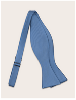 Steel blue bow tie untied against a light neutral background