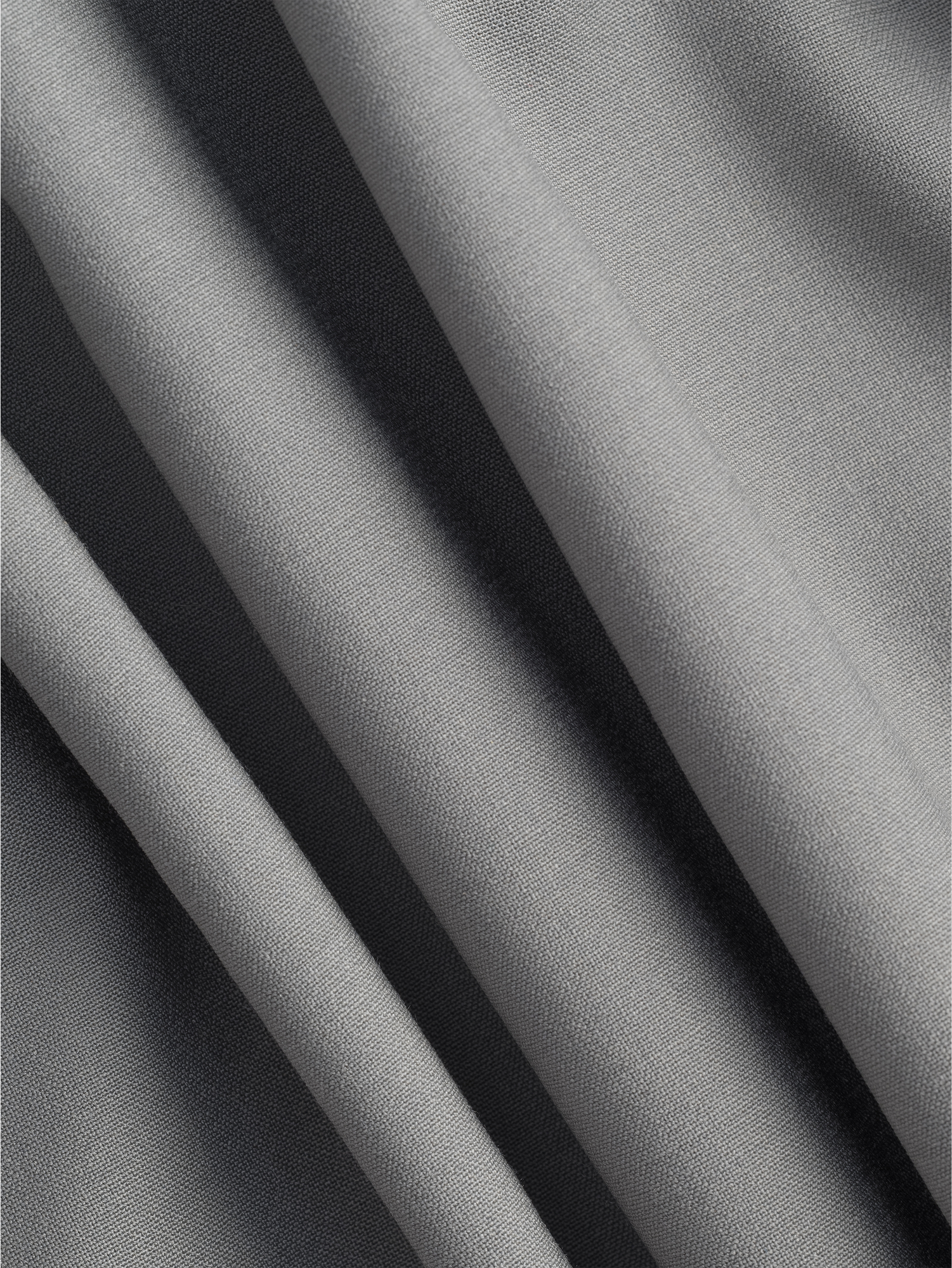 Close-up of folded grey fabric with a smooth texture.