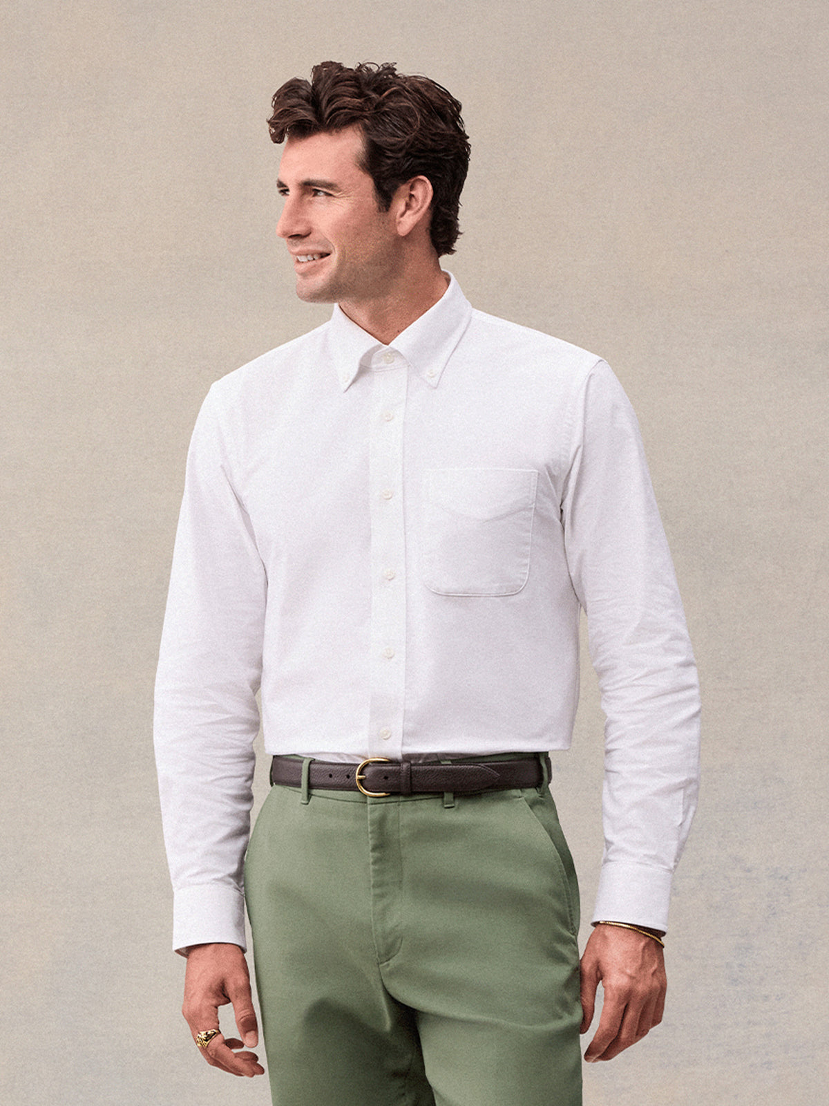 Man in white oxford shirt and olive green  trousers, front view, waist-up