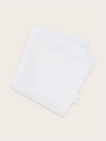 A white silk pocket square folded against a light background