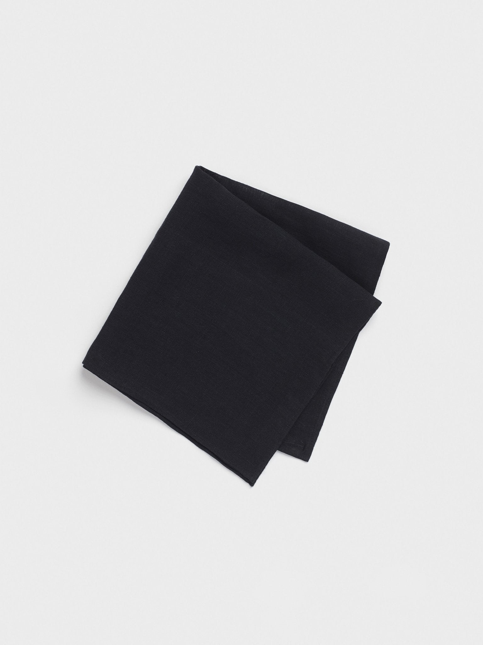 Folded black handkerchief on a white background.
