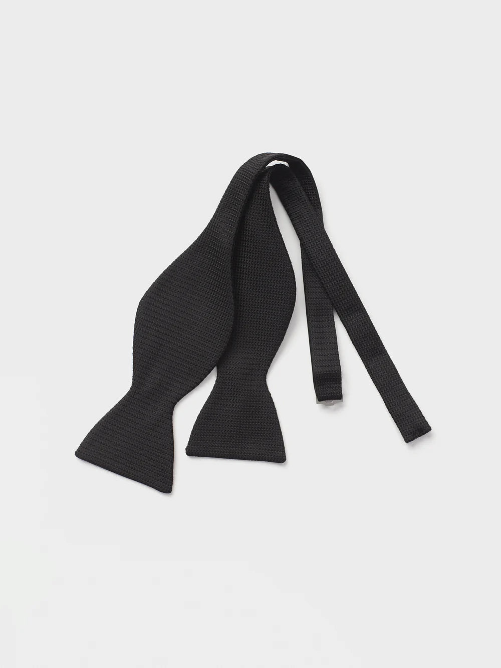 Black knitted bow tie with two ends and a central knot.