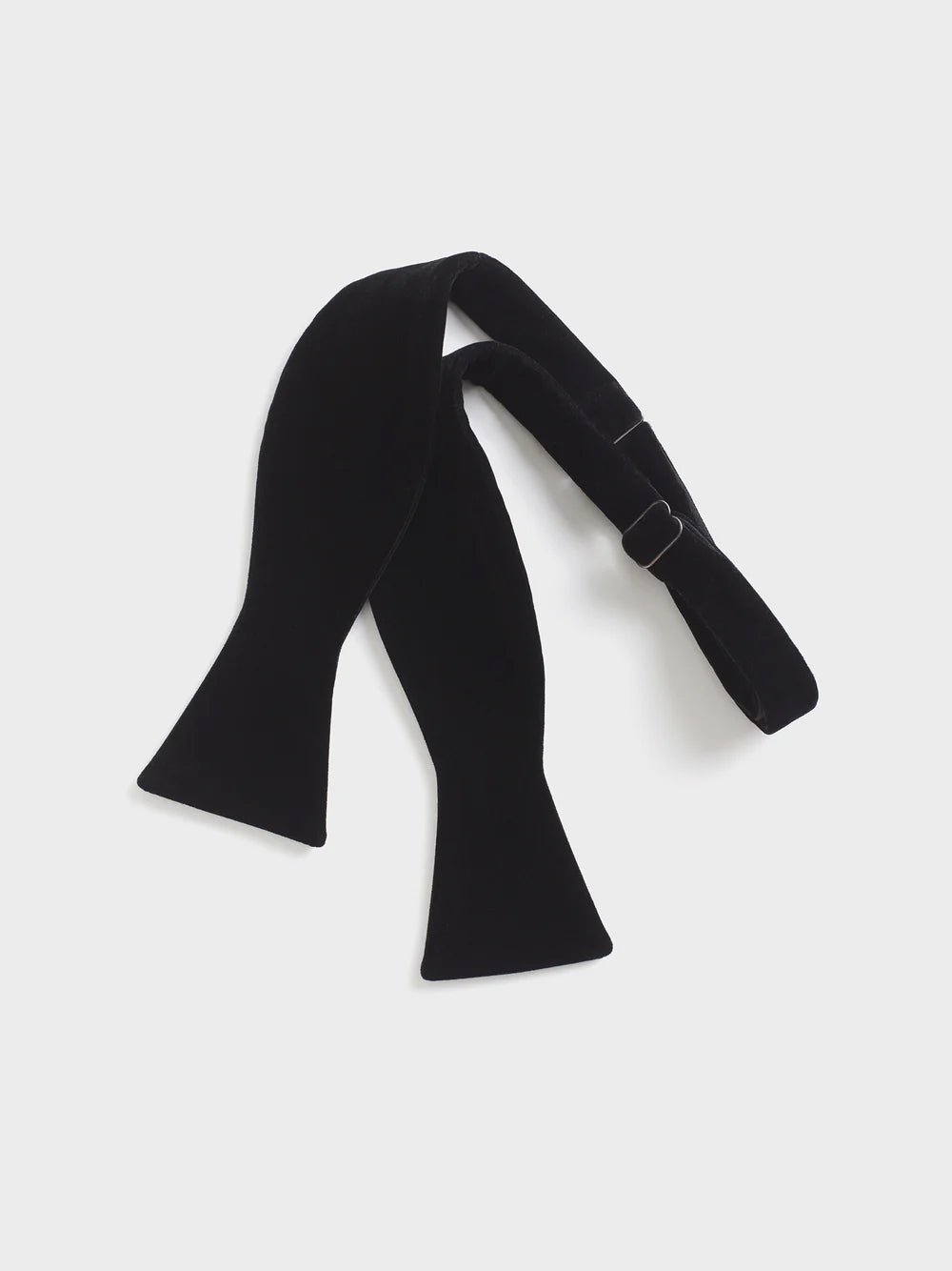 Black velvet bow tie with adjustable strap.