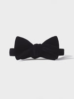 Black velvet bow tie with a knot in the center.