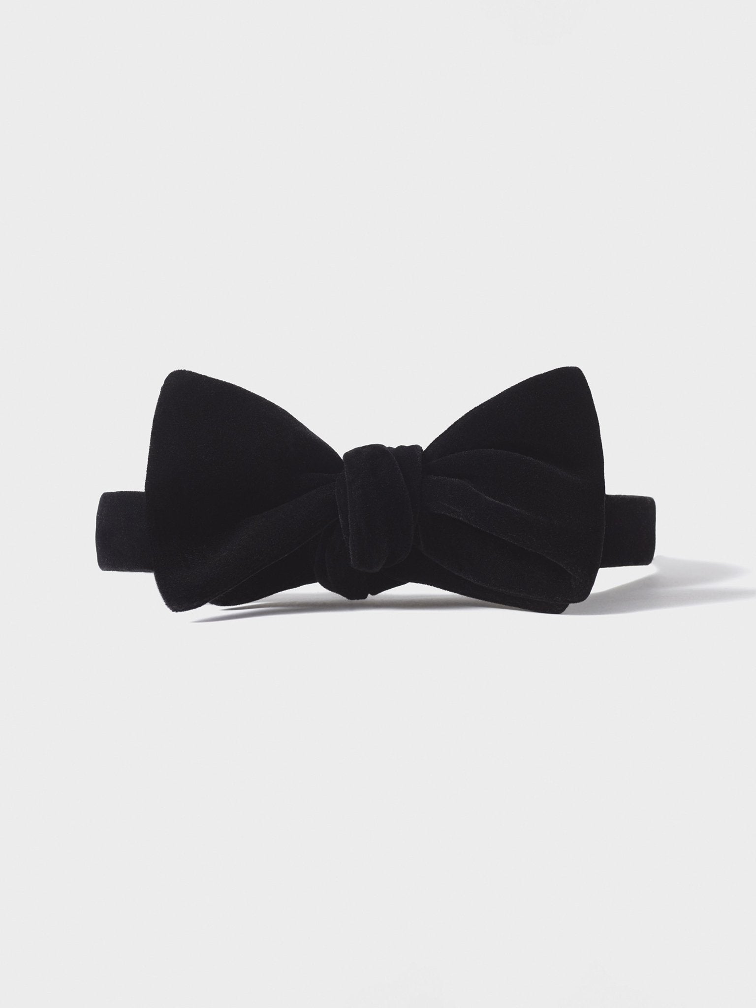 Black velvet bow tie with a knot in the center.