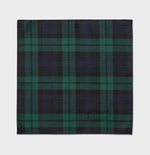 Plaid fabric featuring dark blue, green, and black colors in a checkered pattern.
