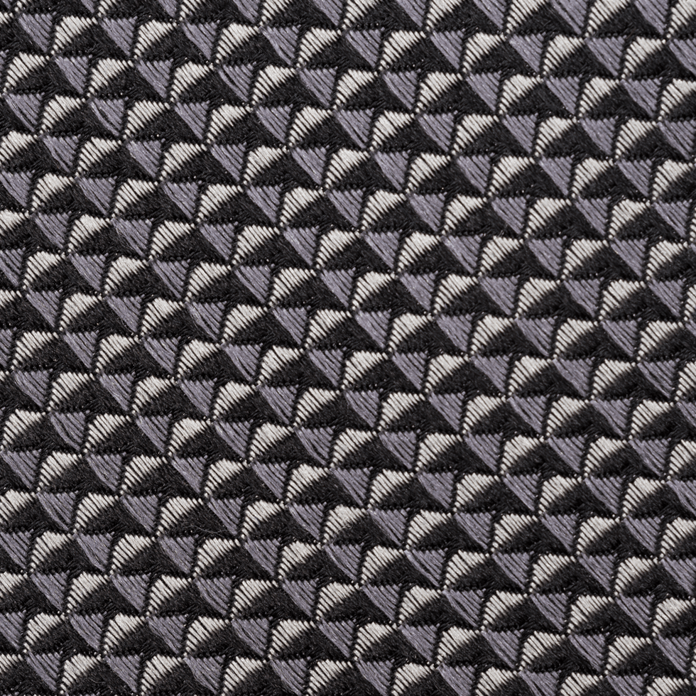 Close-up of a textured fabric with a geometric pattern in shades of gray and black.