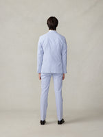 Person wearing a light blue striped suit, viewed from the back.