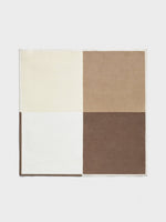 Rectangular rug divided into four color blocks: cream, light brown, dark brown, and white.