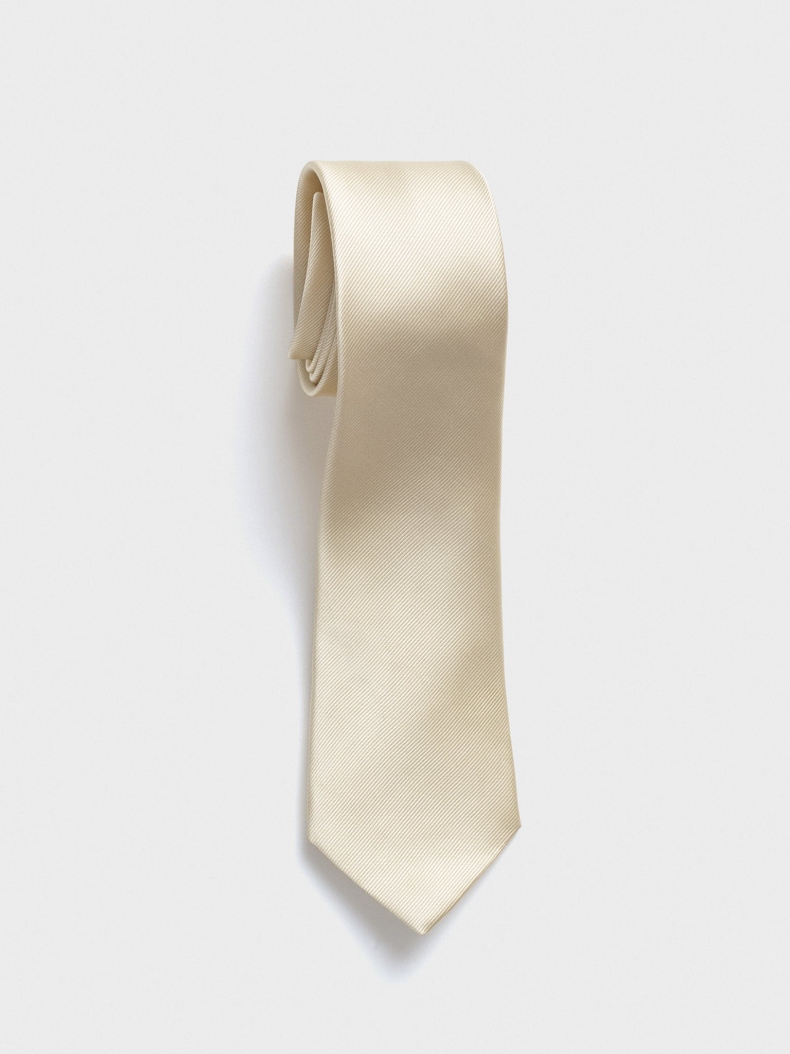 Cream-colored tie displayed against a white background.