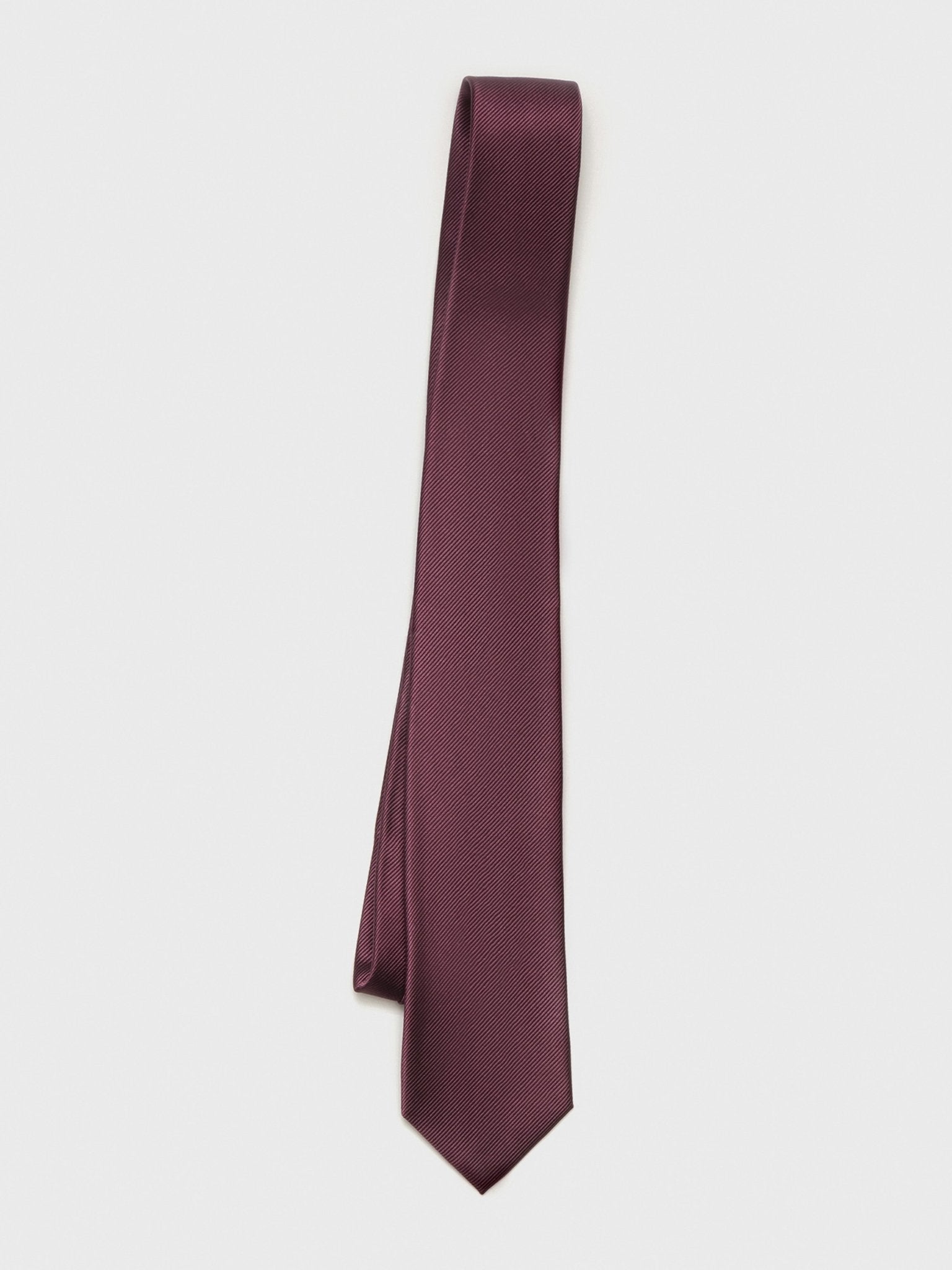 Burgundy tie with a textured pattern, hanging against a white background.