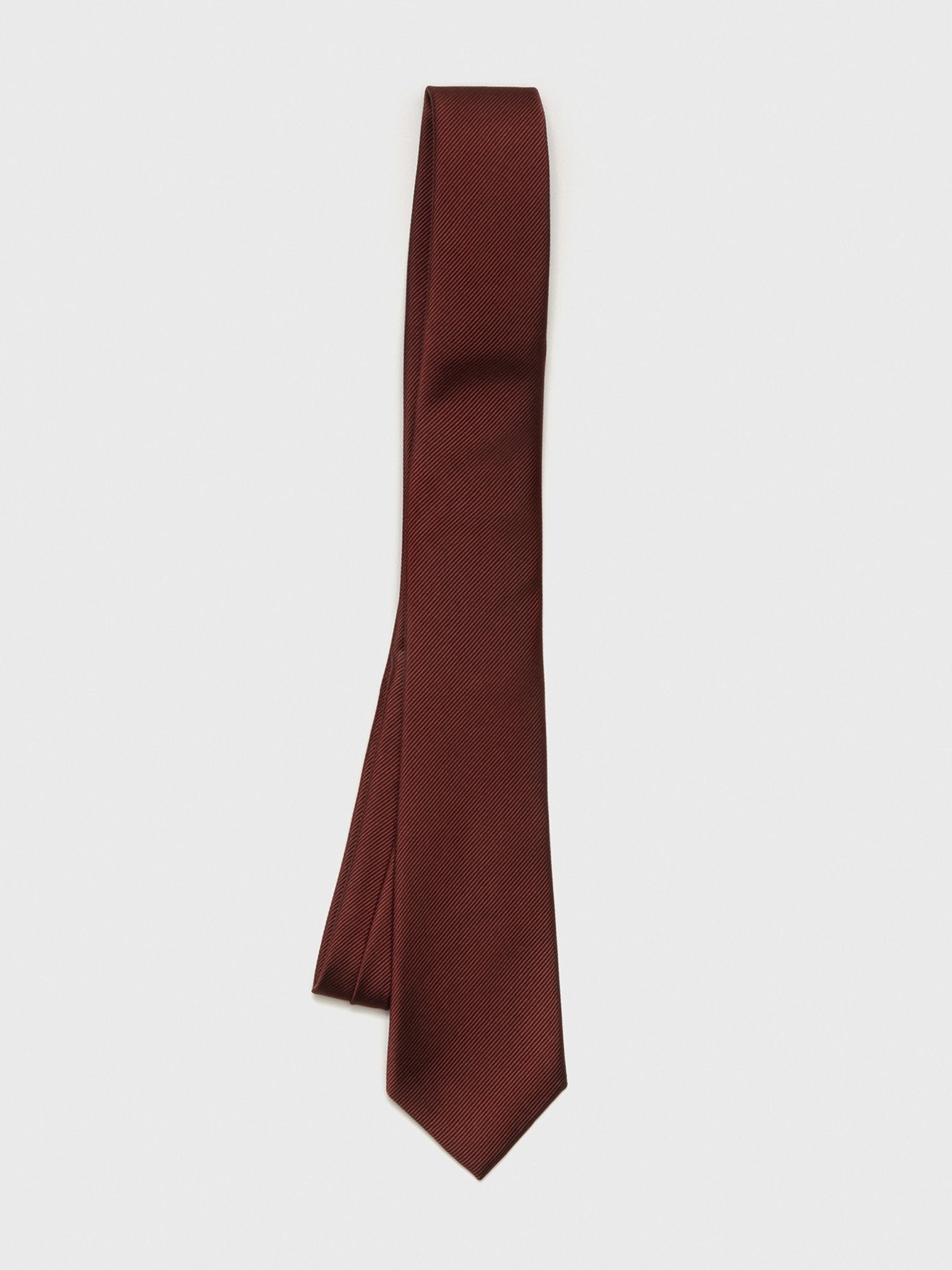 Burgundy tie with a textured pattern, hanging against a white background.