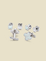 Silver cufflinks with a floral design and a smooth round piece.