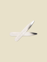 Two metal collar stays with the text 'STAY STIFF' engraved on them.