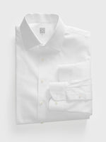Folded white dress shirt with a collar and buttons, featuring a tag.
