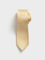 A light yellow tie with a textured pattern, rolled up on a white background.