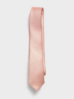 Light pink tie with a textured pattern, hanging against a white background.