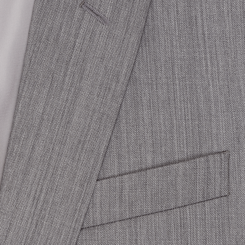Close-up of a grey suit jacket showing the fabric texture and pocket.