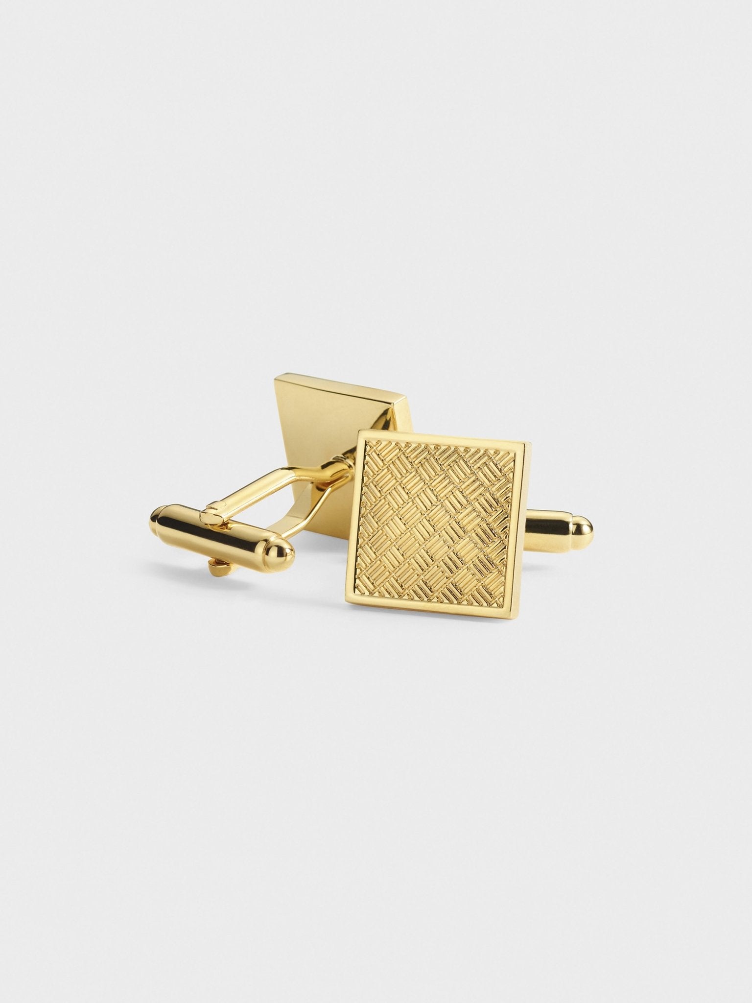 Gold cufflinks with a textured square design.
