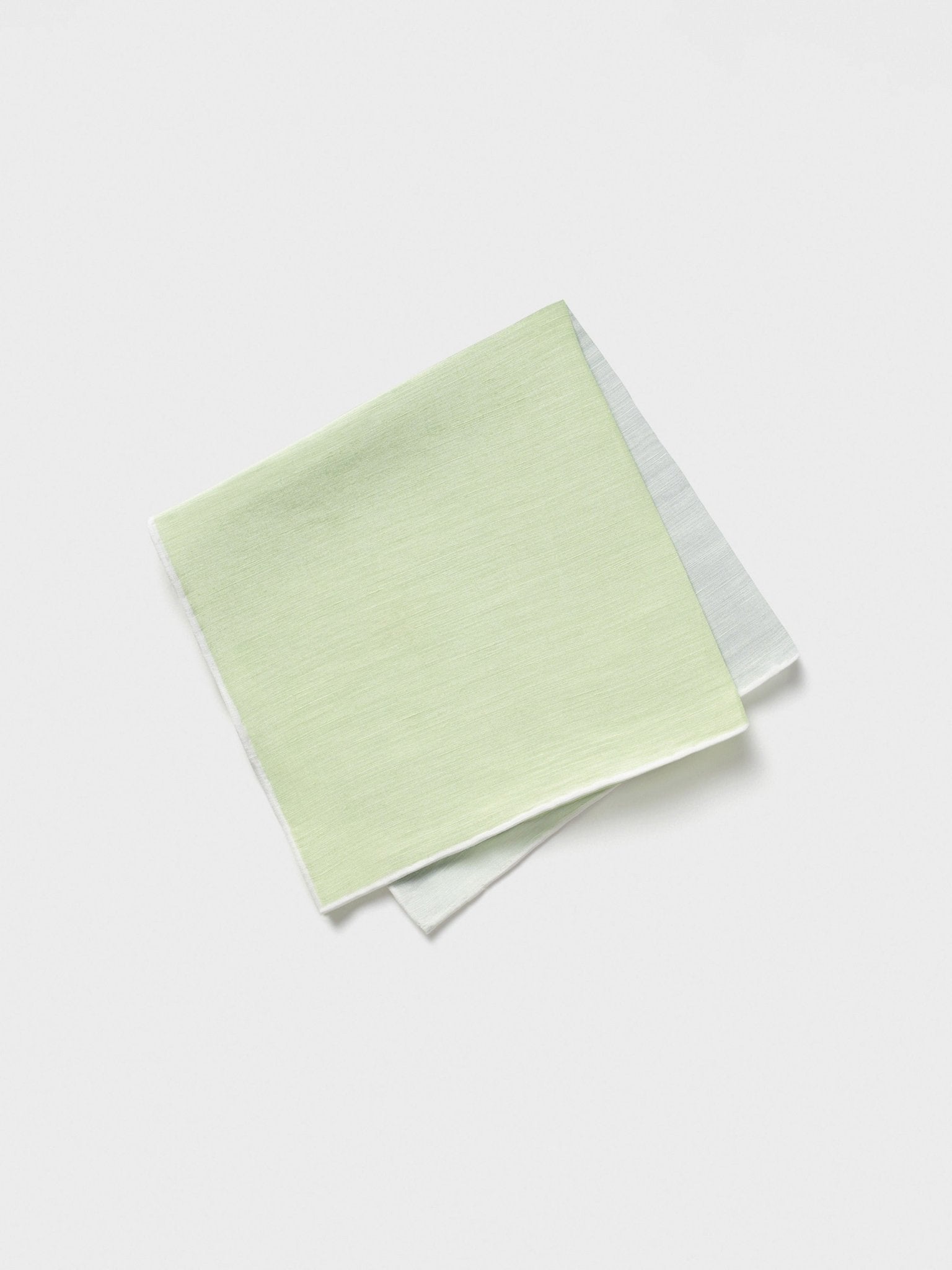 Two folded pocket squares, one light green and one light blue, on a white background.