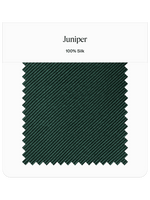 Swatch of dark green fabric labeled Juniper, made of 100% silk.