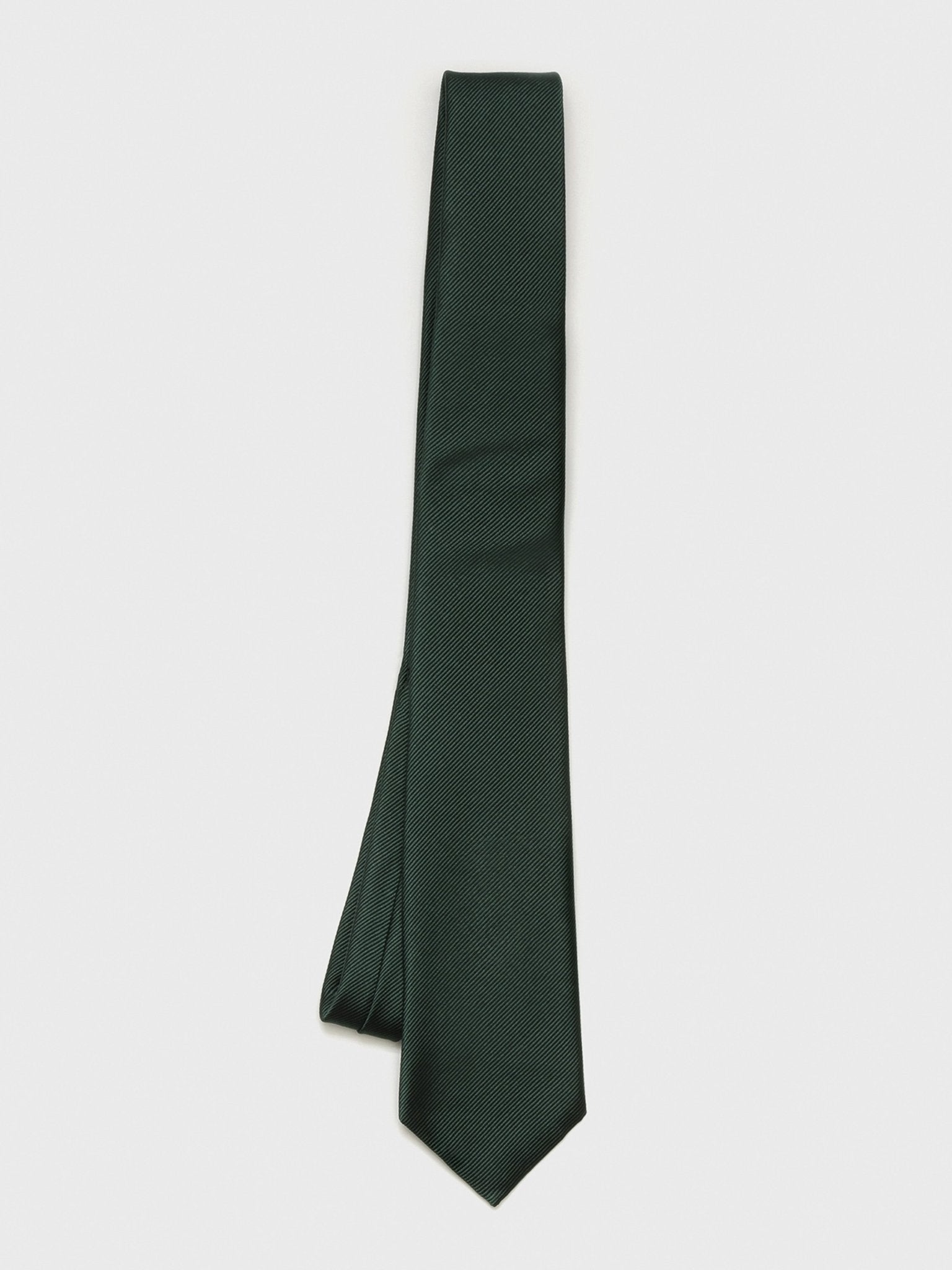 Dark green tie with a textured pattern laid flat on a white background.