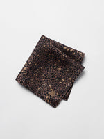 Leopard print pocket square with a tag in the corner.