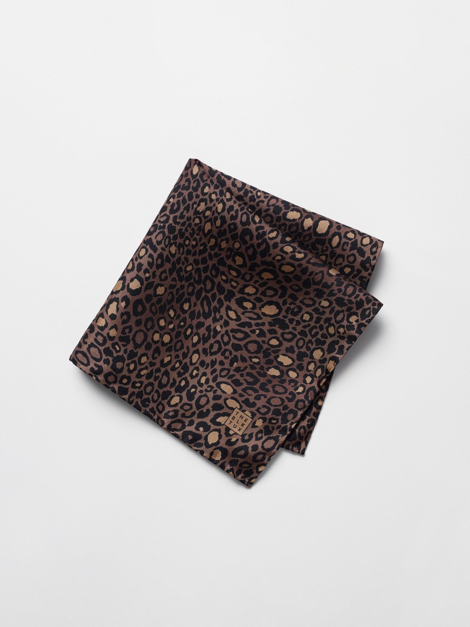Leopard print pocket square with a tag in the corner.