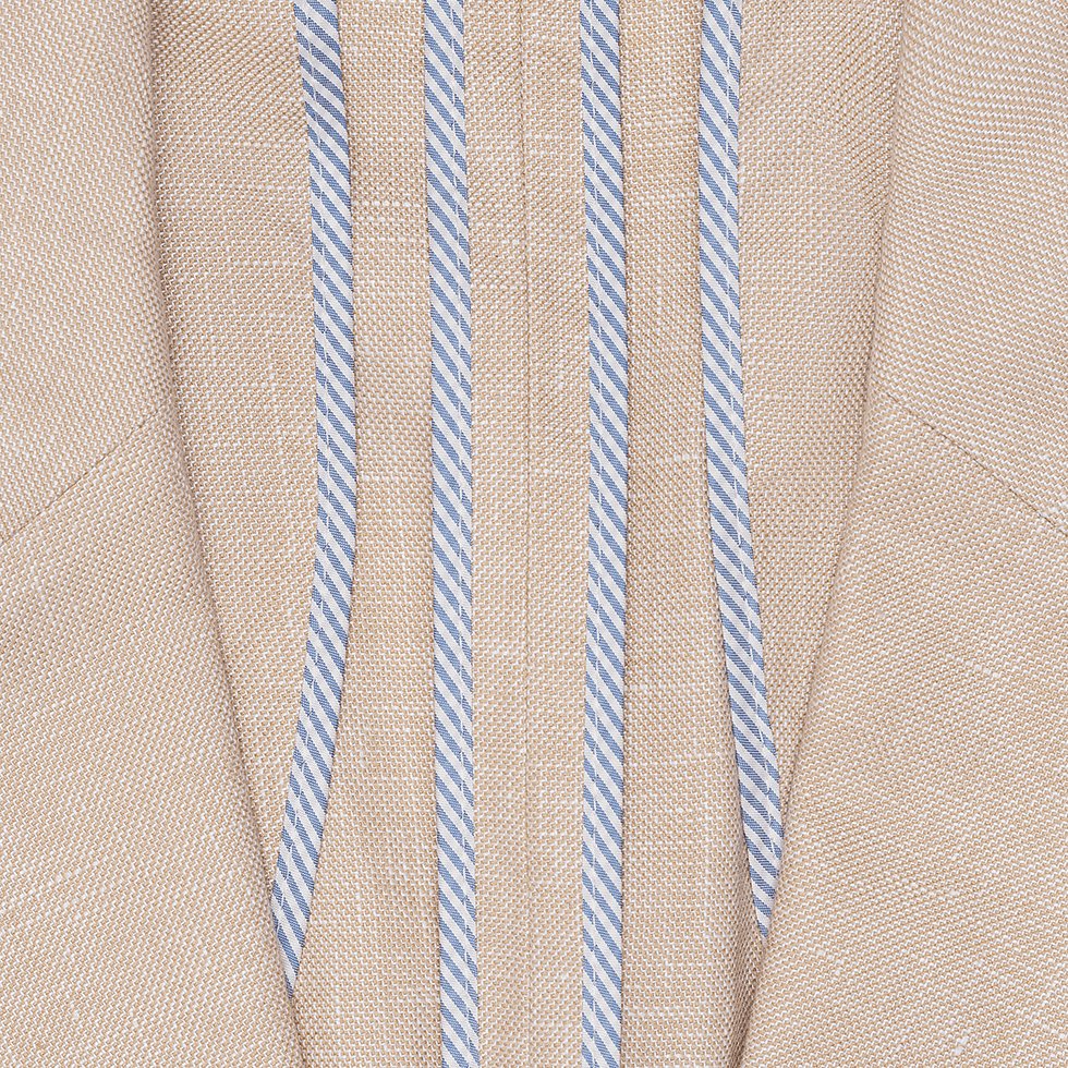 Close-up of a tan fabric with blue and white striped details.