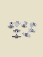 Set of silver cufflinks arranged on a light background.