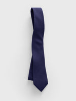 Navy tie displayed against a light background.