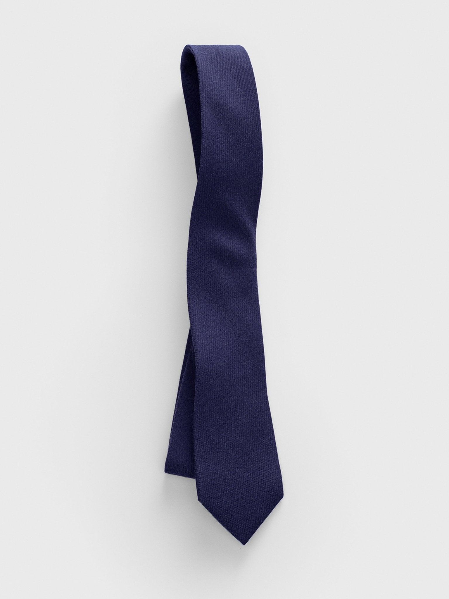 Navy tie displayed against a light background.