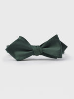 Dark green bow tie with a textured finish on a white background.