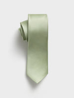 Light green tie with a textured pattern, rolled up on a white background.