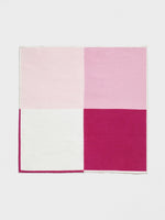 A square fabric with four sections in varying shades of pink and white.